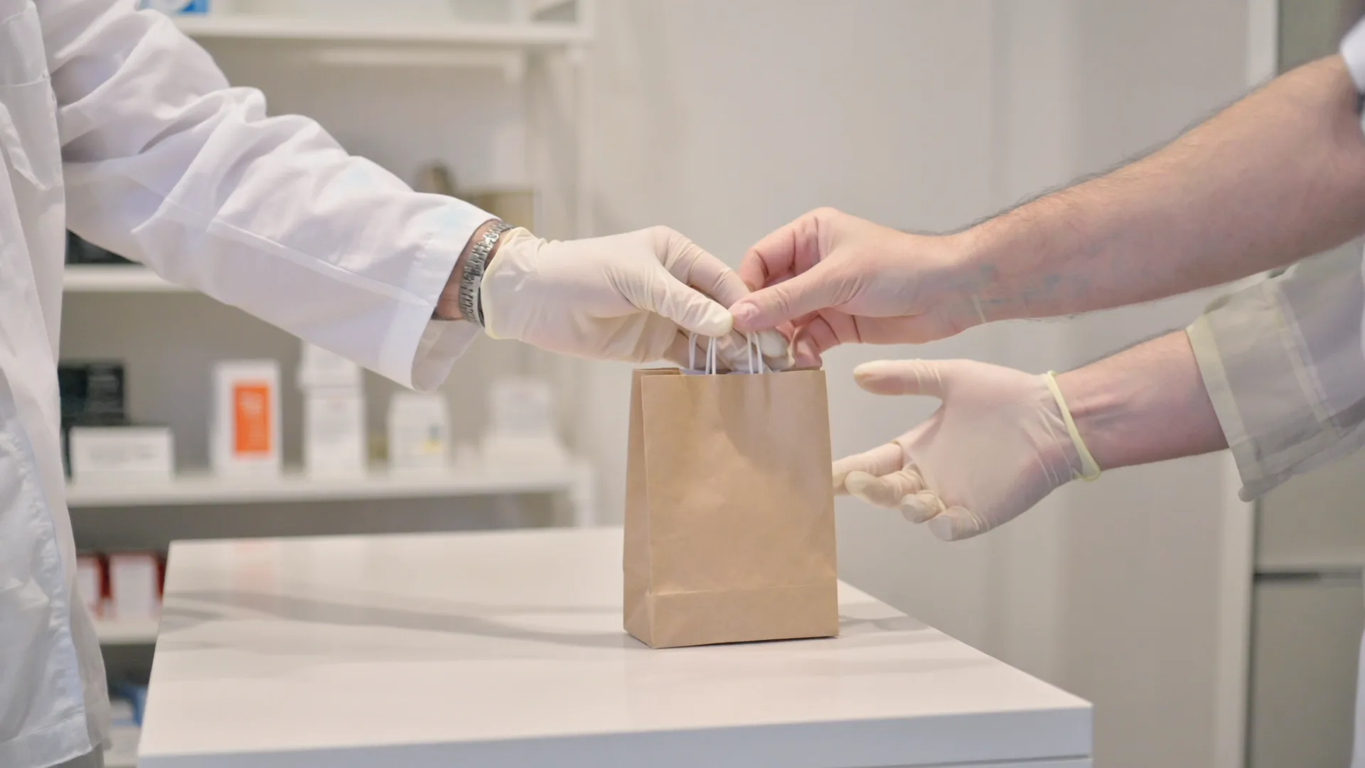 A registered pharmacy and a valid prescription are the licensed route A pharmacist's hands handing a sealed paper bag across a pharmacy counter