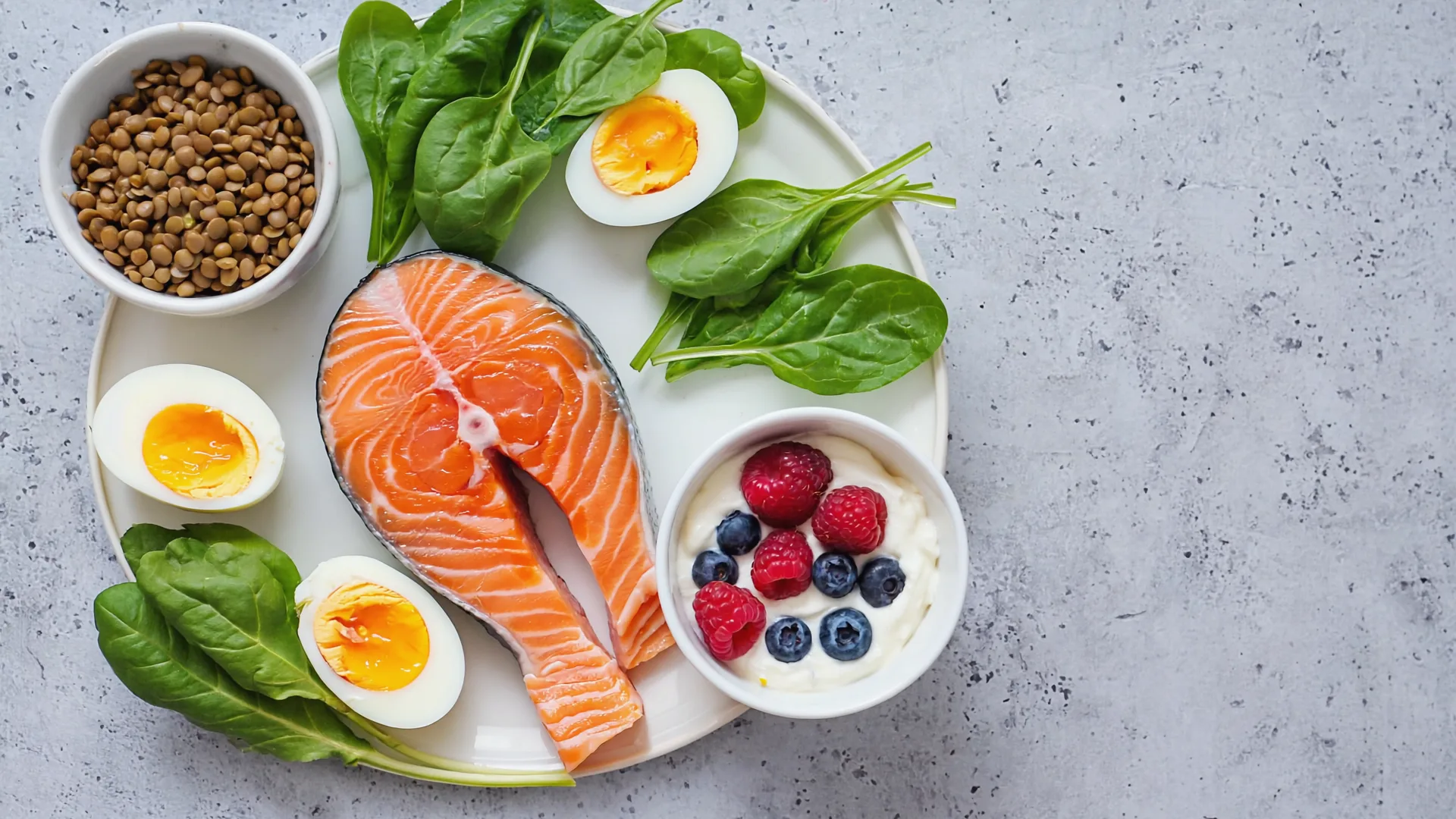 Enough protein and iron-rich food matters when your appetite is lower A balanced plate of salmon, eggs, spinach and lentils on a light kitchen counter