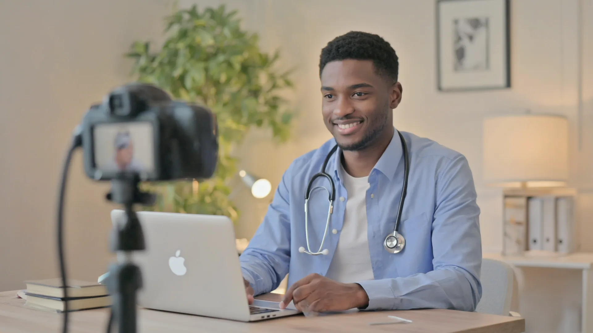Ongoing clinician review is part of what you're buying Doctor in a bright home office on a video consultation, screen an abstract blur